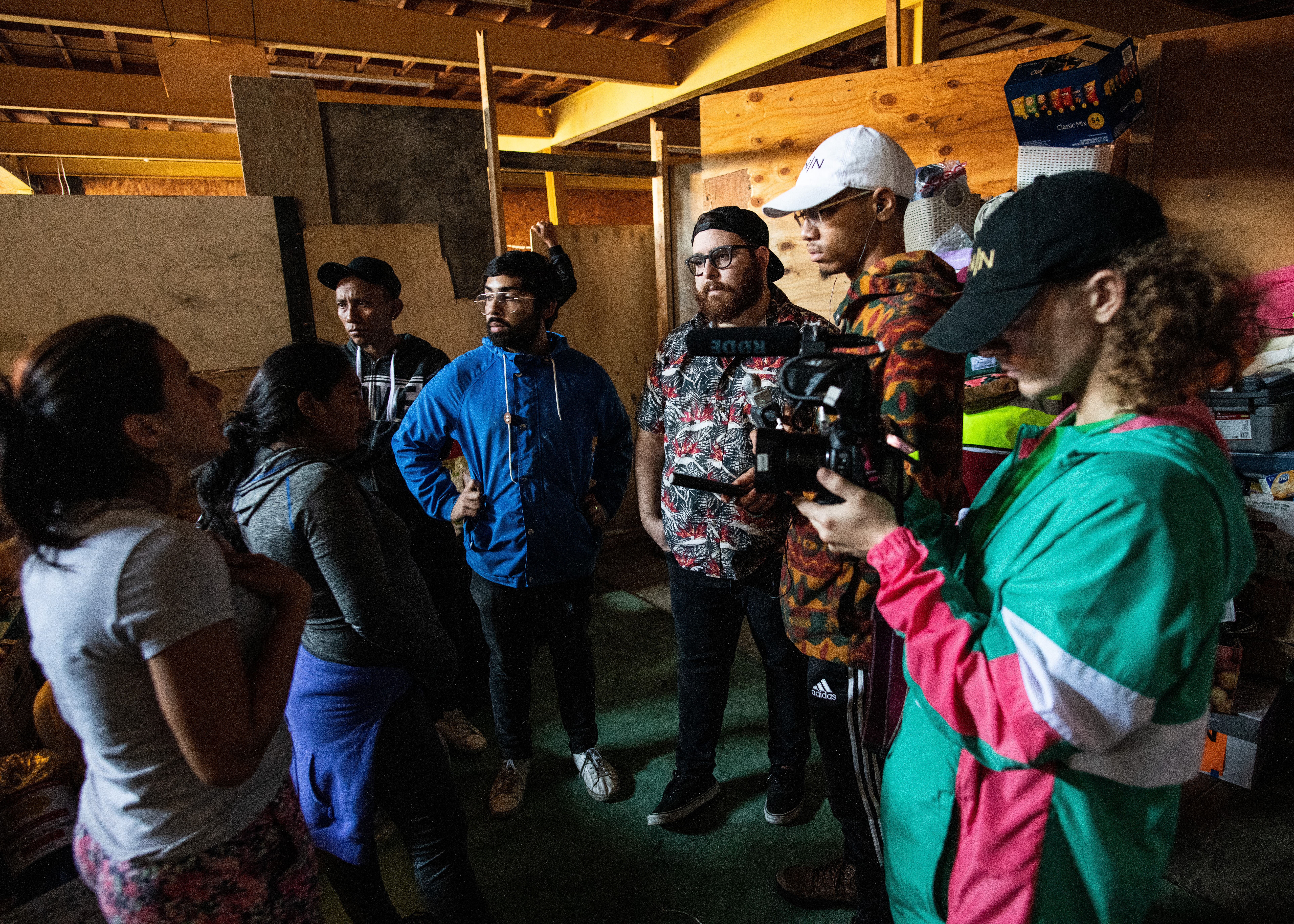 Kian Kelley-Chung ’20 (second from right) Interviews Brenda (far left) and her aunt Leticia (second from left), two migrants from Honduras who volunteer in the pantry and kitchen of "Contra Viento y Marea," a migrant-run shelter in Tijuana, Mexico, where they also live. Dec. 20, 2018 (Photo by Paul Lai).
