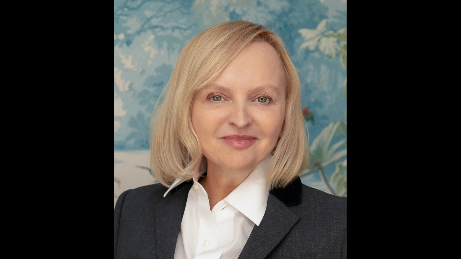 Headshot of Danuta Hinc wearing white shirt and black jacket