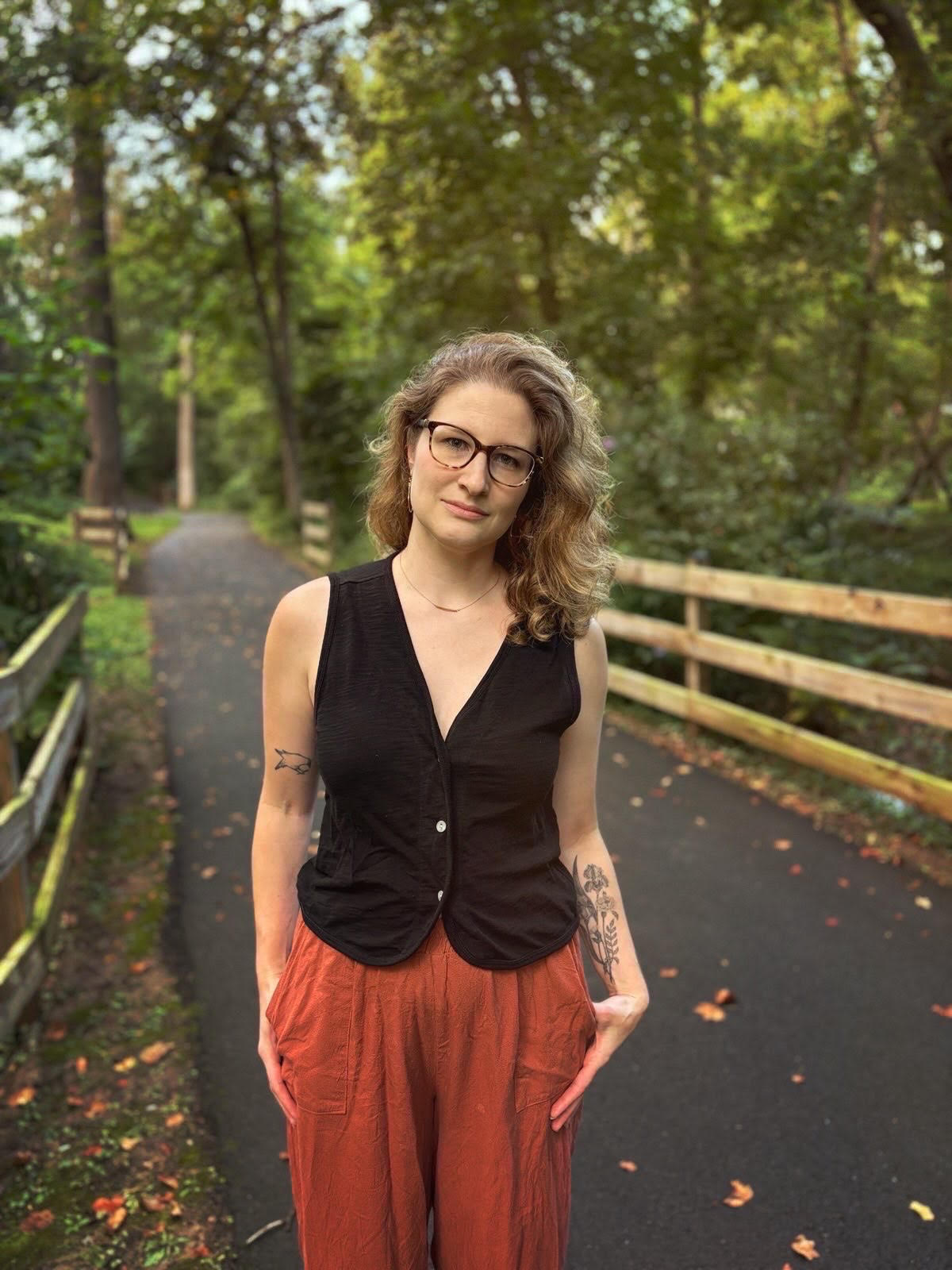 Woman standing on a wooded path
