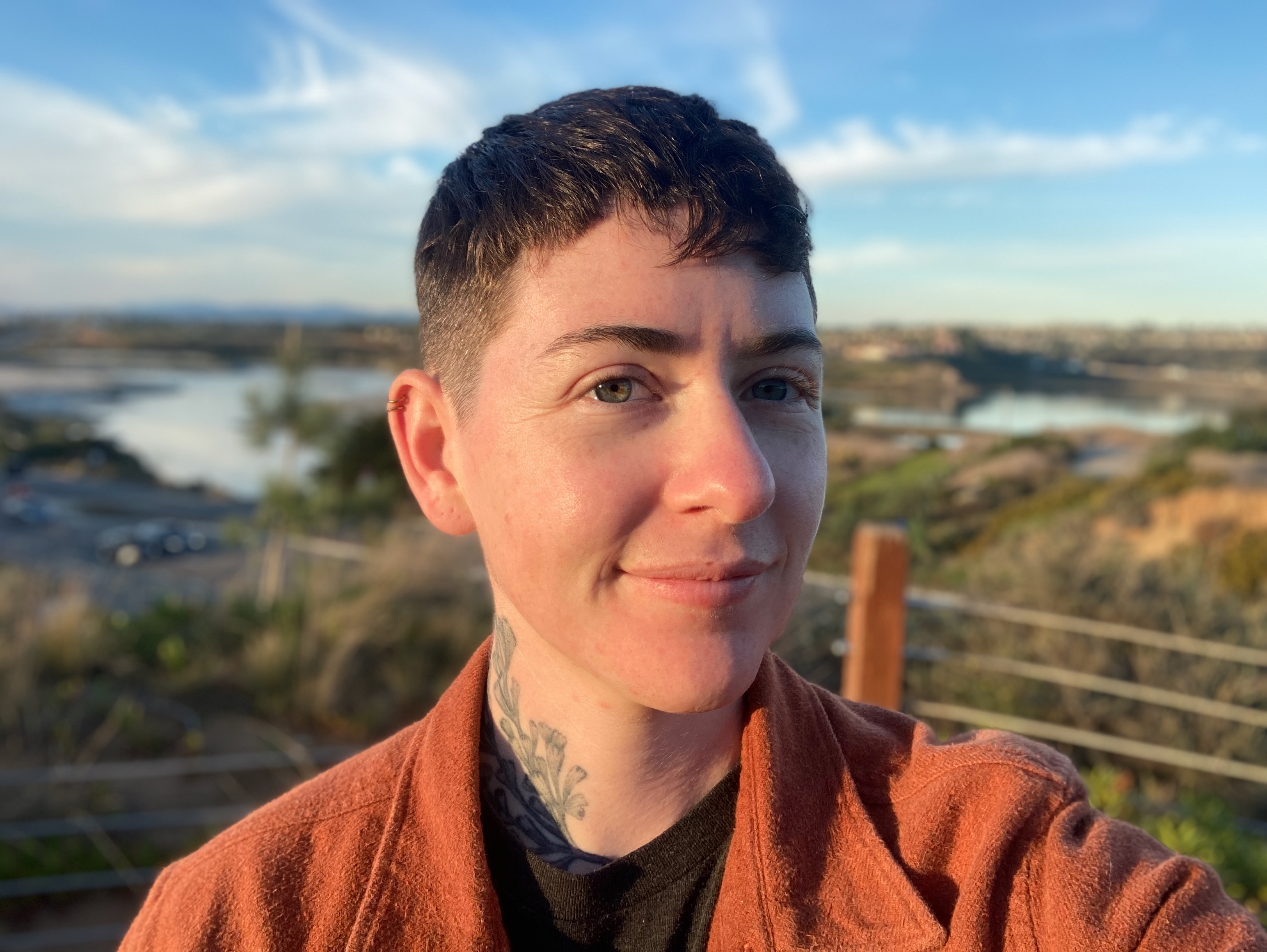 Profile picture: Person smiling with landscape behind