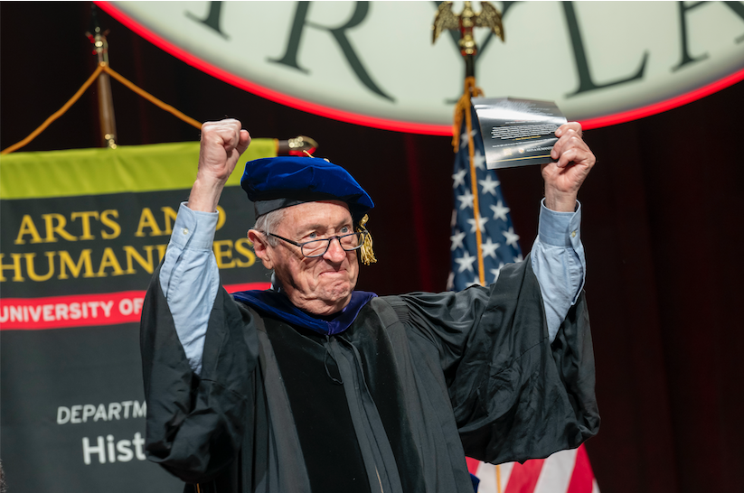 Michael Olmert cheers on stage at commencement