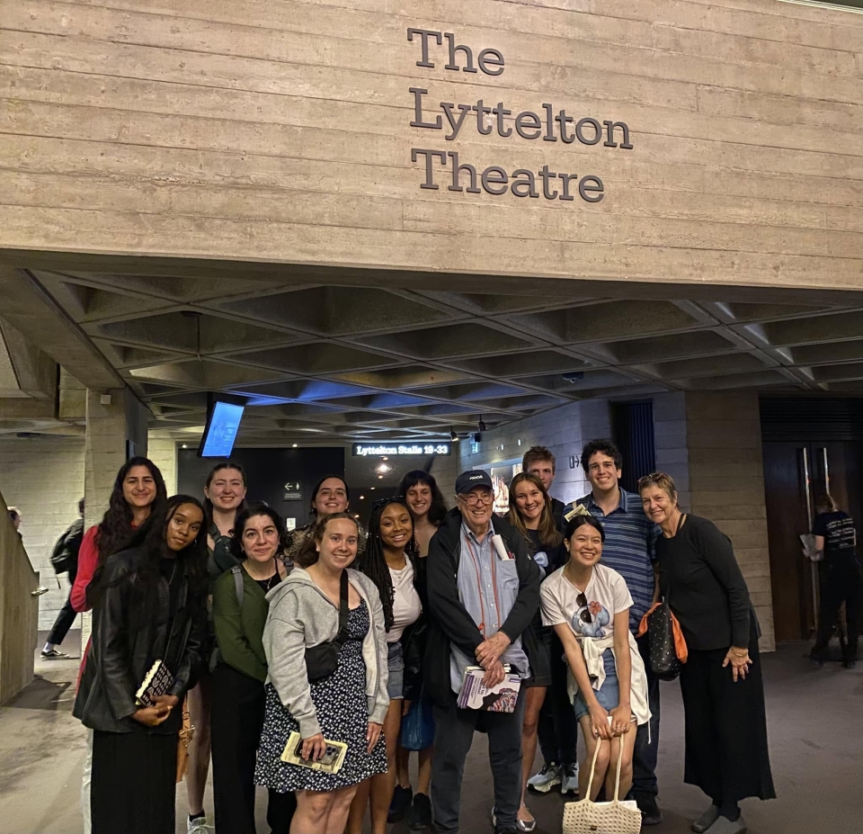 Olmert (center right) smiles for a group photo with students in front of the Lyttelton Theatre in London.